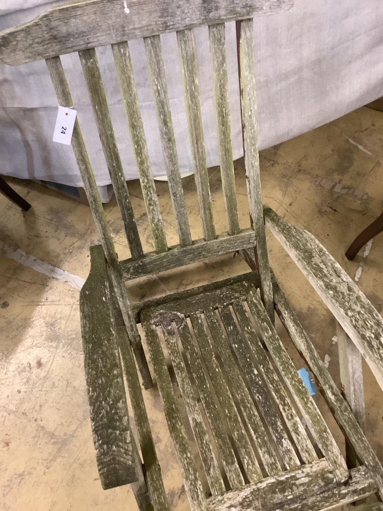 A weathered teak folding garden steamer chair